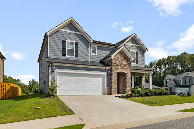 craftsman house featuring a garage and a front yard