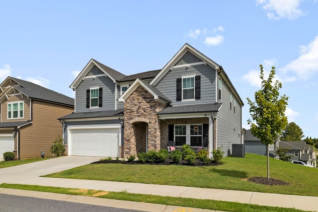 craftsman house with a garage, central air condition unit, and a front yard