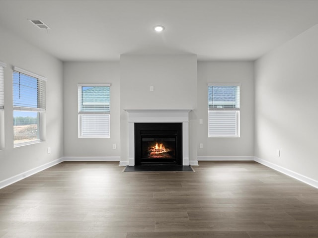 unfurnished living room featuring dark hardwood / wood-style flooring