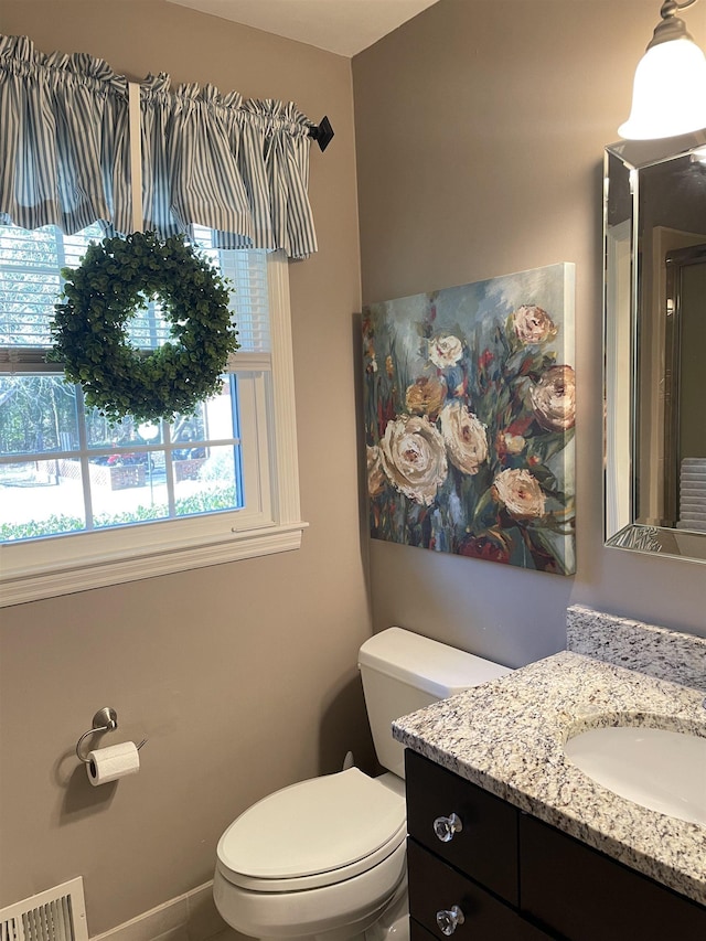 bathroom with vanity and toilet