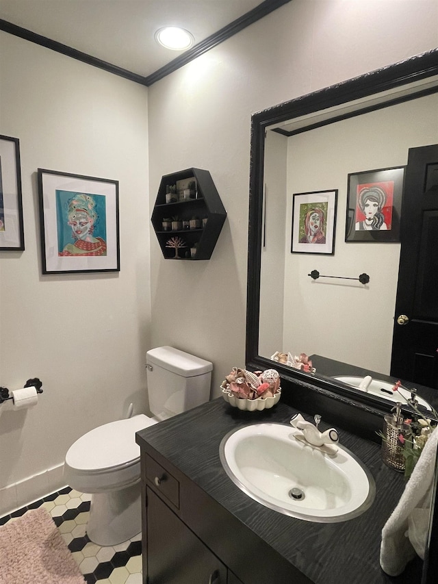 bathroom with vanity, toilet, and ornamental molding