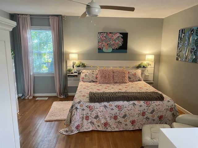 bedroom with wood-type flooring and ceiling fan