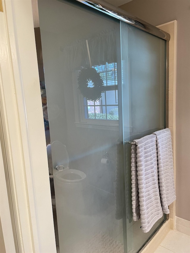 bathroom with tile patterned flooring and an enclosed shower