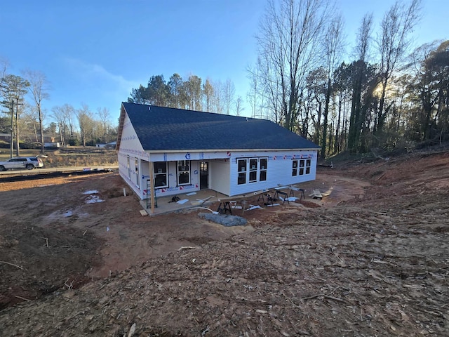 rear view of house featuring a porch