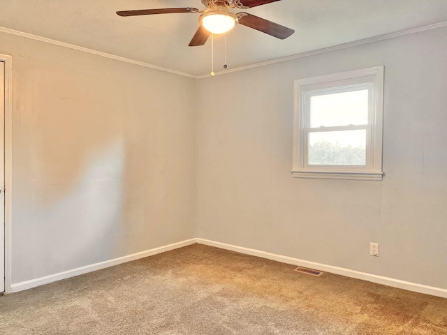 carpeted spare room featuring ceiling fan and ornamental molding