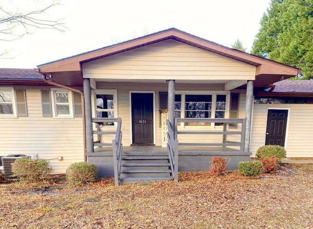 bungalow-style house with cooling unit and covered porch