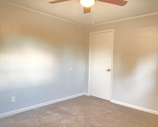 spare room with crown molding, carpet floors, and ceiling fan