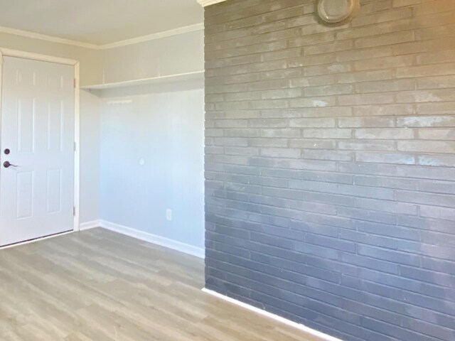 unfurnished room featuring hardwood / wood-style flooring and crown molding