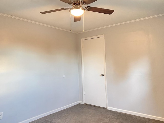 unfurnished room with ceiling fan, crown molding, and dark carpet