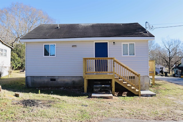 back of property featuring a lawn