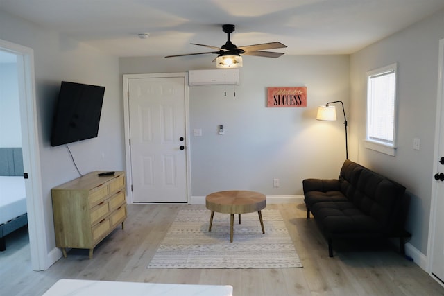 living room featuring light wood-type flooring, a wall mounted AC, and ceiling fan