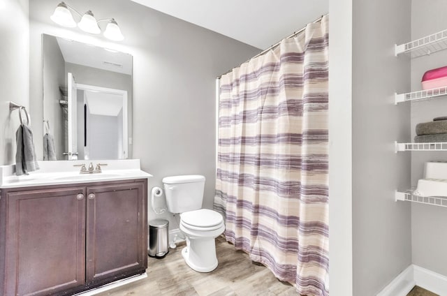 bathroom featuring a shower with shower curtain, vanity, wood-type flooring, and toilet