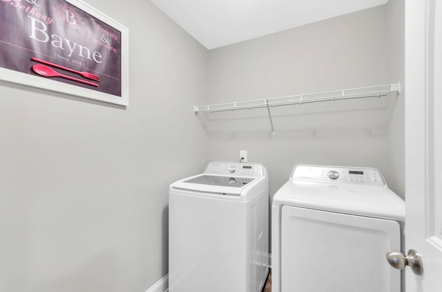 clothes washing area with washing machine and dryer