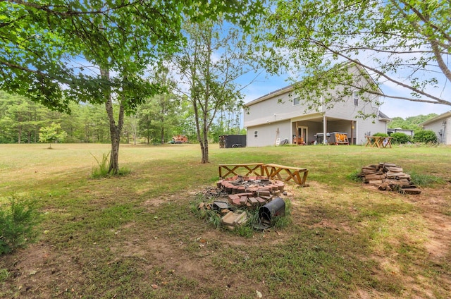 view of yard with an outdoor fire pit