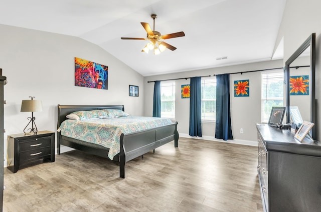 bedroom with hardwood / wood-style floors, vaulted ceiling, and ceiling fan