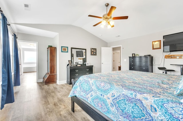 bedroom featuring ceiling fan, light hardwood / wood-style flooring, and vaulted ceiling