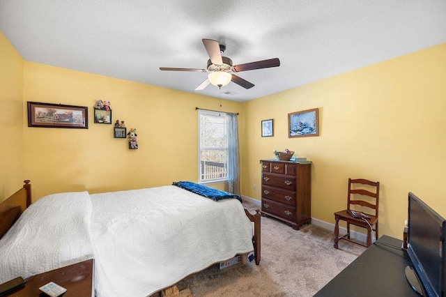 bedroom with ceiling fan and light carpet