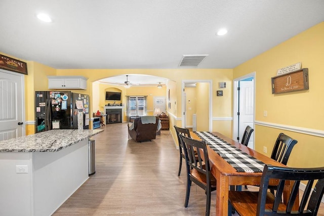 dining room featuring light hardwood / wood-style floors and ceiling fan