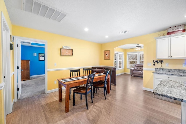 dining room with ceiling fan and light hardwood / wood-style floors