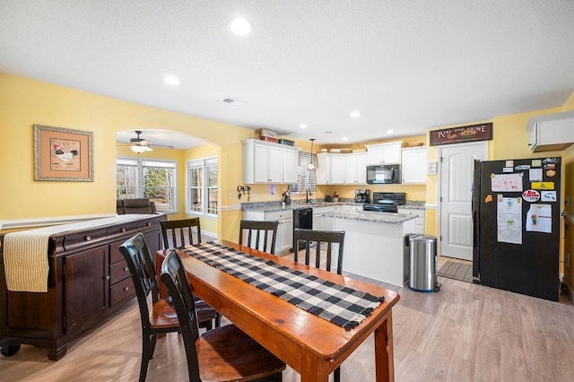 dining area featuring ceiling fan, light hardwood / wood-style floors, and sink