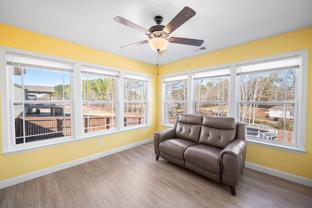 sunroom with ceiling fan and a healthy amount of sunlight