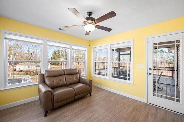 sunroom / solarium featuring ceiling fan