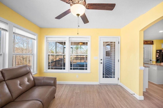 sitting room featuring a wealth of natural light, ceiling fan, and light wood-type flooring