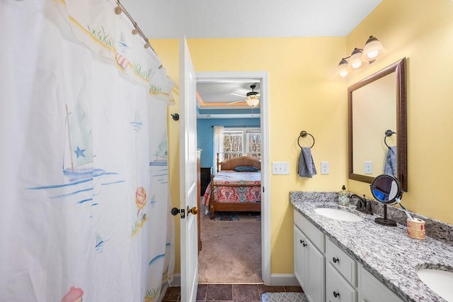 bathroom with tile patterned floors, ceiling fan, and vanity