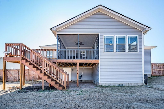 back of property featuring a yard, ceiling fan, and a sunroom