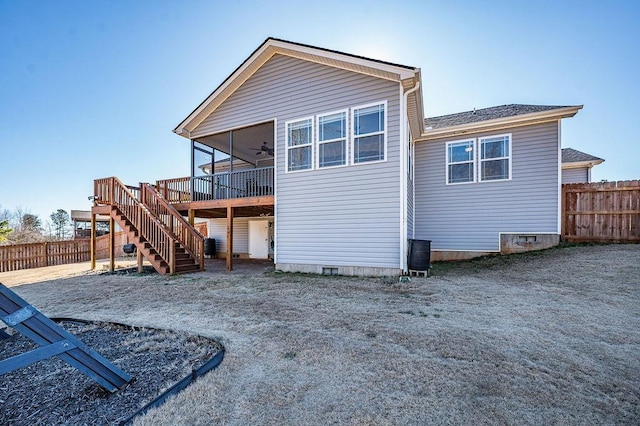 back of property with ceiling fan and a wooden deck