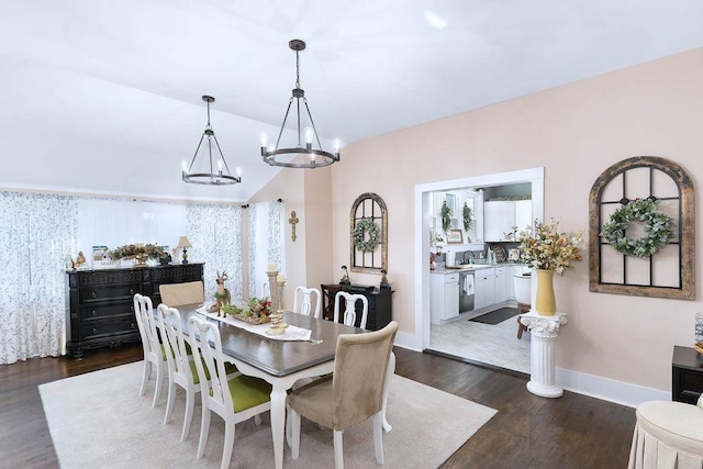 dining area featuring a chandelier, dark hardwood / wood-style floors, and sink