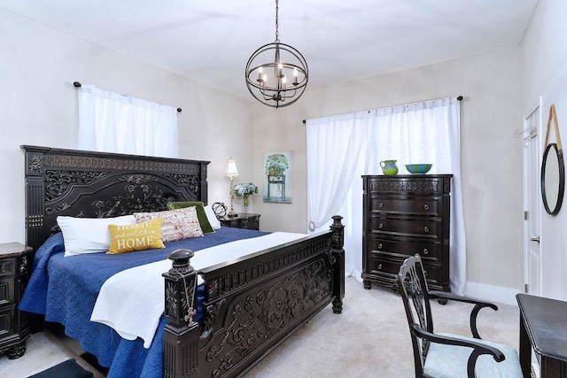 bedroom featuring a chandelier and light colored carpet