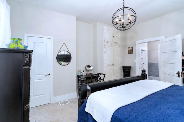 bedroom featuring a chandelier and light colored carpet