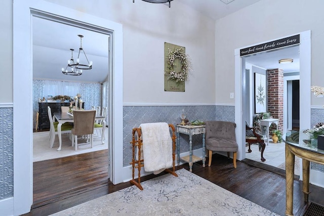 sitting room with a chandelier and wood-type flooring