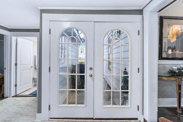 doorway to outside with crown molding and french doors