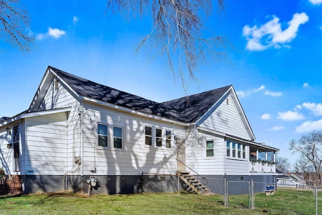 rear view of property featuring a yard