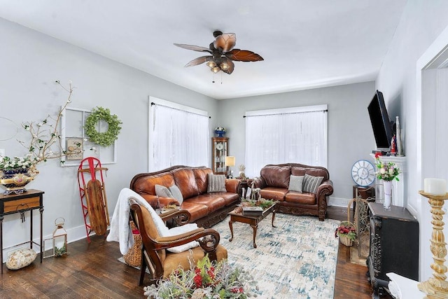 living room with ceiling fan and dark wood-type flooring