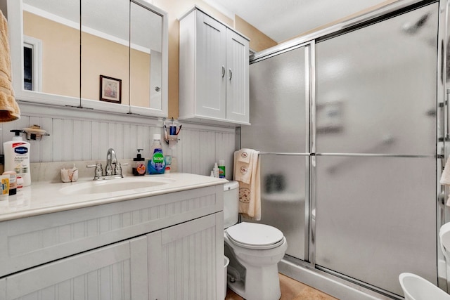 bathroom with vanity, toilet, and walk in shower