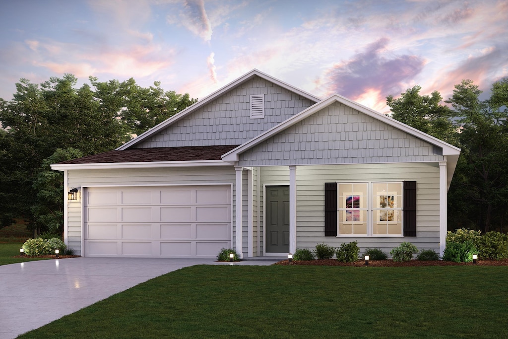 view of front of house with a garage and a lawn