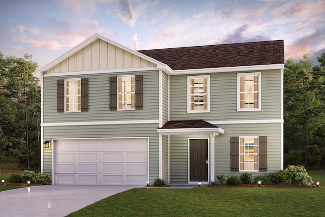 view of front of house featuring a yard and a garage