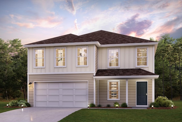 view of front of property featuring a lawn and a garage