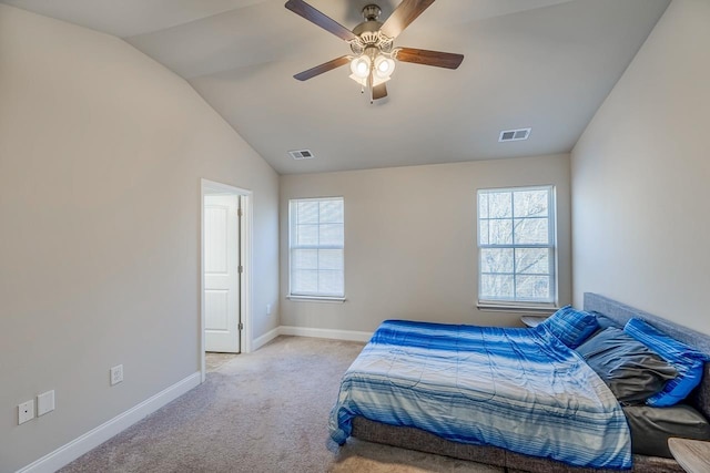 bedroom featuring multiple windows, ceiling fan, light colored carpet, and lofted ceiling