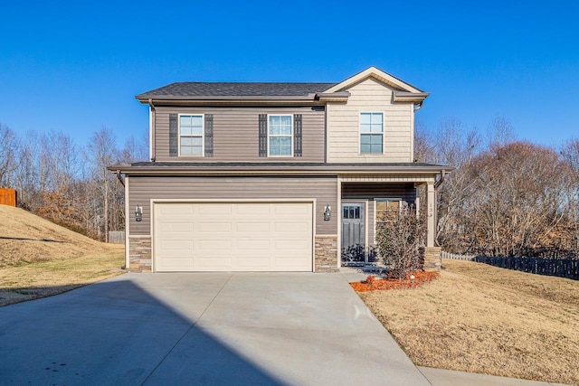 view of property featuring a garage and a front yard