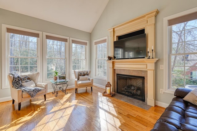 sunroom / solarium featuring a fireplace and vaulted ceiling