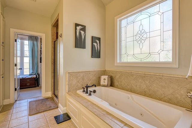 bathroom featuring tile patterned floors, independent shower and bath, and vaulted ceiling