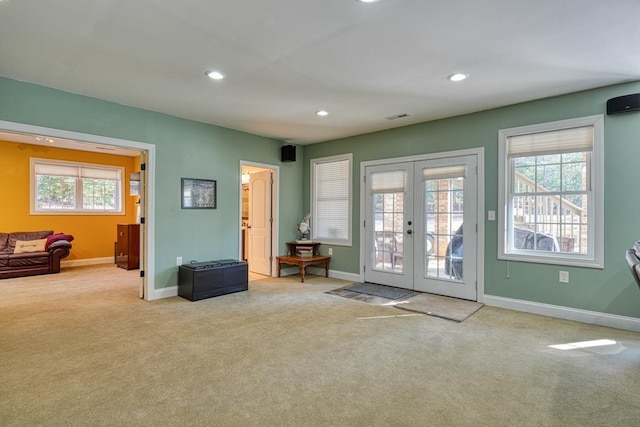 doorway to outside with french doors and light colored carpet