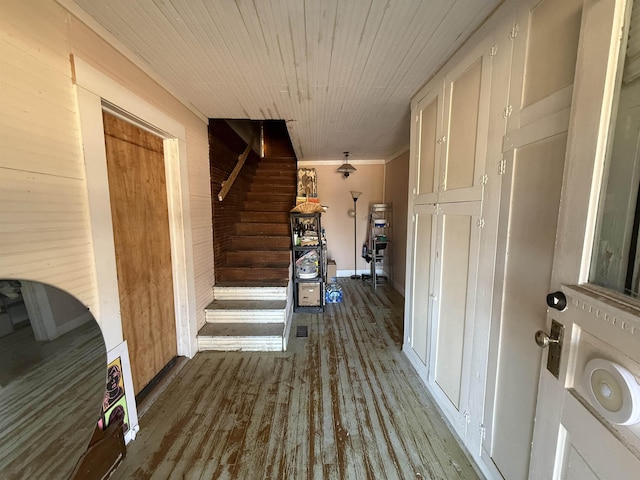 corridor featuring wood-type flooring, wooden walls, and wooden ceiling