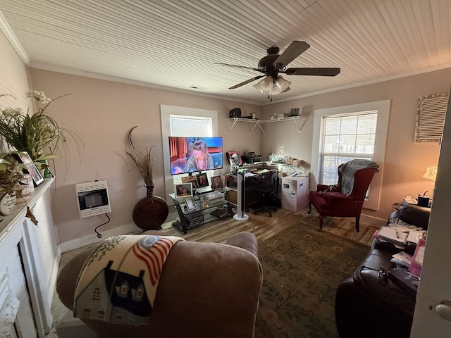 living room featuring hardwood / wood-style flooring, ceiling fan, crown molding, and heating unit