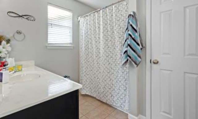 bathroom with tile patterned floors and vanity