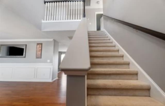 stairway with hardwood / wood-style floors